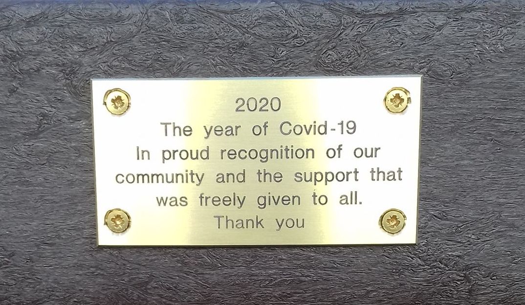 The plaque on the bench